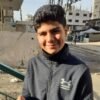 gaza boy in paletine gaza holding mobile smiling