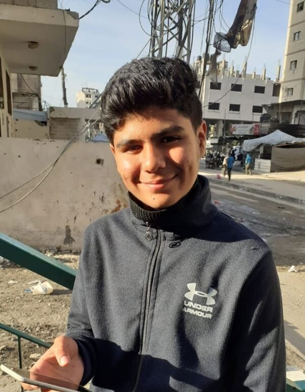gaza boy in paletine gaza holding mobile smiling